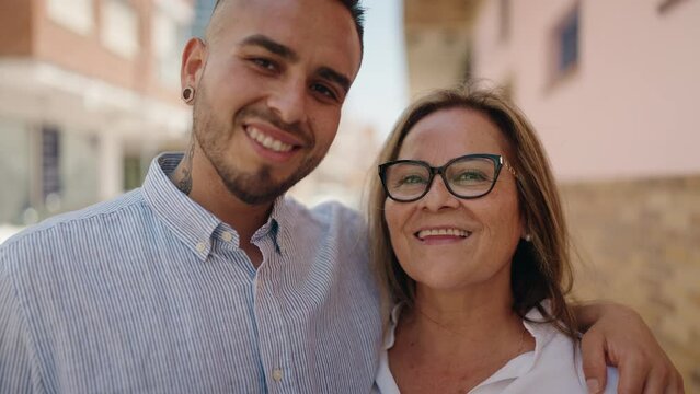 Man and woman mother and daugther hugging each other at street
