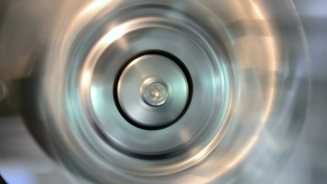 rotated silver industrial metal ring closeup with vibrance effect, permanent motor vibration, industry oscillation, flutter diversity