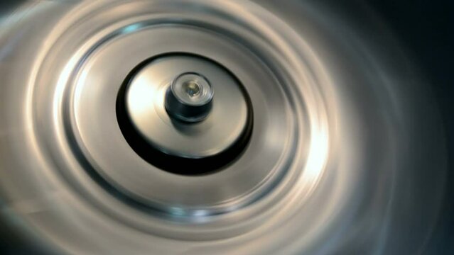 rotated silver industrial metal ring closeup with vibrance effect, permanent motor vibration, industry oscillation, flutter diversity