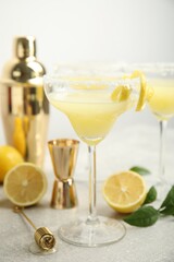 Delicious bee's knees cocktail and ingredients on light grey table