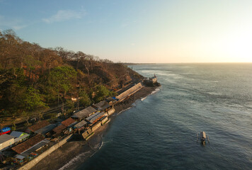 Fototapeta na wymiar Beautiful sunrise at Watudodol beach in Banyuwangi, East Java, Indonesia seen from drone.