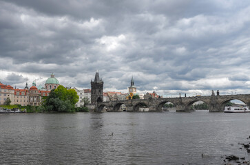 Fototapeta na wymiar Scenic view of of the Vltava river, Charles Bridge and Old Town Bridge Tower in Prague
