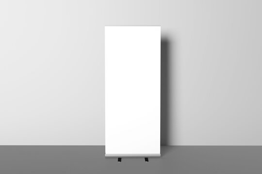 Blank white roll-up banner display mockup on gray background, isolated, 3d rendering. Ready to present your design