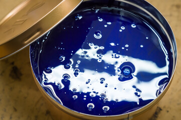 A can of blue polygraph offset paint for the printing press. Special UV ink for printing. Cyan...