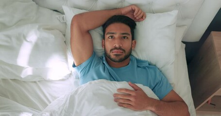 Thinking man, insomnia and sleeping bed in house with anxiety, stress about mental health and anxiety in bedroom in home. Sad Asian person with depression, tired from mistake and idea for problem