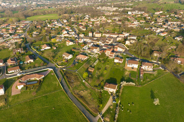 Fototapeta na wymiar Aerial view of residential houses in green suburban rural area