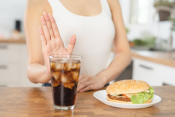 Diet, Dieting hand of asian young woman deny, avoid hamburger, junk or fast food and sparkling...