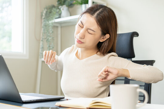 Body muscles stiff problem, ache asian young woman, girl pain back, stretch while sitting work on chair at home, holding massaging rubbing, hurt or sore, Healthcare people, office syndrome .
