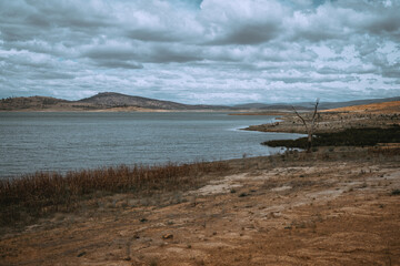Barren lake edge with brown grass