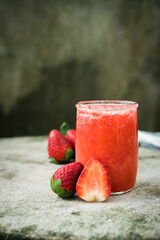  strawberry smoothie with fresh strawberry fruit on dark blackground