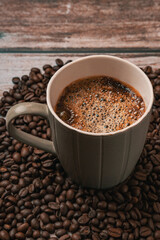 cup of coffee with beans on a table