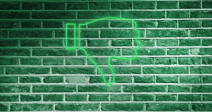 Image of glowing neon thumb down icon on brick wall - Powered by Adobe