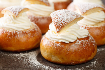 Sweet buns with frangipane and whipped cream close-up on the table. Horizontal
