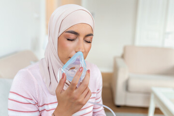 Sick muslim woman with hijab on oxygen mask inhalation, pneumonia coronavirus pandemic. ill woman...