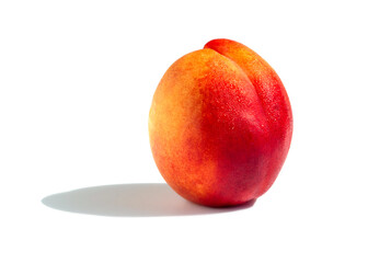 Yellow-red ripe peach in drops of water on a white background