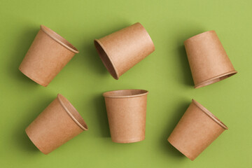 Eco-friendly, zero waste concept. Many craft cups on green background. Top view