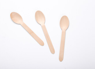 Three wooden spoons on a white background. Eco products