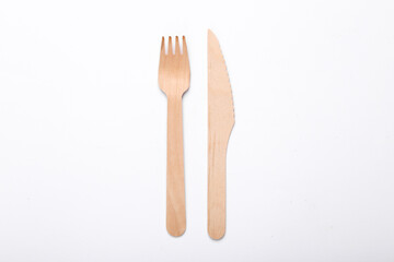 Wooden knife and fork on a white background. Eco products