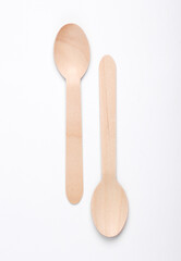 Two wooden spoons on a white background. Eco products