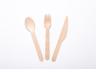 Wooden knife, spoon and fork on a white background. Eco products