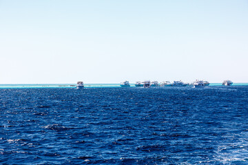 Diving boats in the sea on position fr diving and empty blue sky