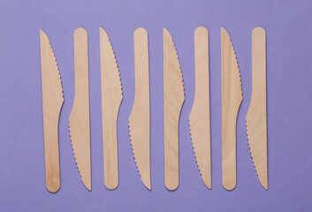 Set of wooden knives on a purple background. Eco concept. plastic free, zero waste