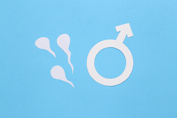 Spermatozoa and male gender symbol on a blue background. Man's health