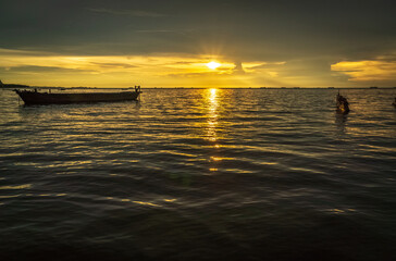 Fototapeta na wymiar sunset at sea with silhouette of boat. beautiful sunset sky. sea landscape.