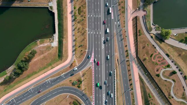 Drone flying over a road junction with passing cars.