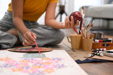 Happy young woman painting picture with watercolor at cozy home. Art, creative hobby and leisure...
