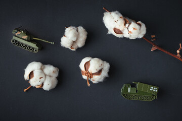 Model toy of battle tank firing cotton flowers from the barrel. Trendy Ukrainian banter about...