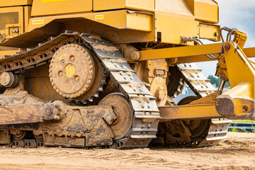 Powerful crawler bulldozer close-up at the construction site. Construction equipment for moving large volumes of soil. Modern construction machine. Road building machine.