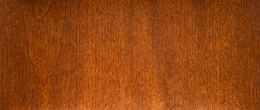 Rectangular photo of mahogany texture. Wooden background for banner-shaped text. The background is made of natural wood.