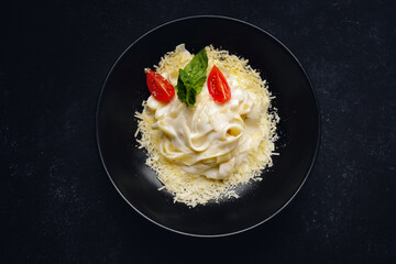 Pappardelle with cheese, sauce and tomatoes. horizontal