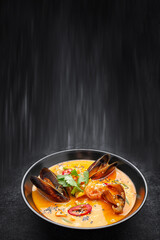 Thai soup in a plate with seafood