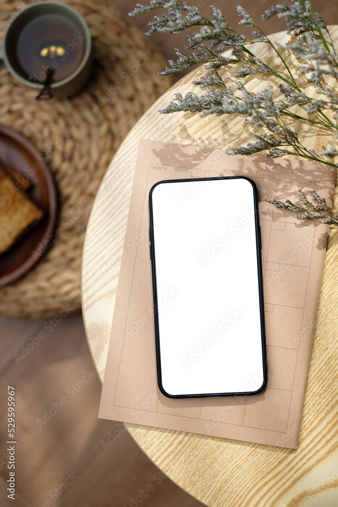 Poster mockup blank screen mobile on round table with sunlight