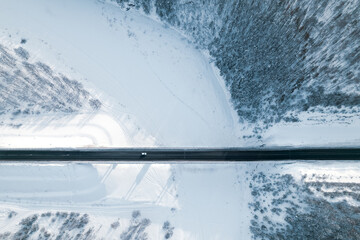 aerial view of the bridge in winter, a lone car drives over the bridge