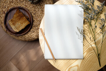 Fototapeta na wymiar Mockup notepad with pencil on round table