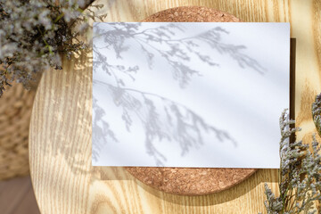 Mockup paper poster card  on round table with grass flower