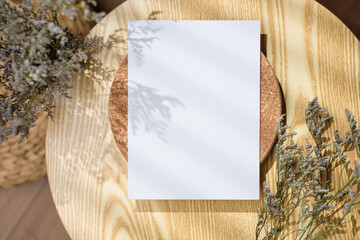 Mockup paper poster card  on round table with grass flower