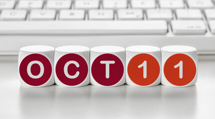 Letter dice in front of a keyboard - October 11