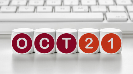 Letter dice in front of a keyboard - October 21