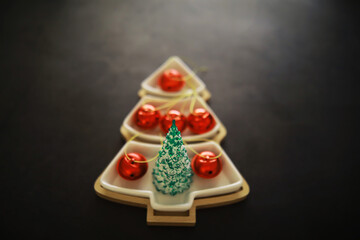 Christmas background. Dish in the shape of a Christmas tree with balls decorations on the table.