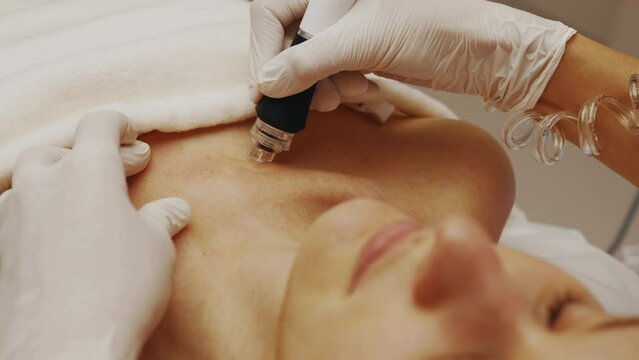 A professional cosmetologist performs hydropiling on a woman. Skin care.
