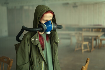 post apocalyptic woman, living in abandoned building wearing gas mask under tattered hood