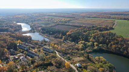 View from a height of the autumn forest and lakes in the Kharkiv region 