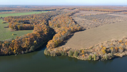 View from a height of the autumn forest on the banks of the river