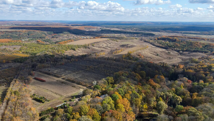 Fototapeta na wymiar View from a height of the autumn forest and agricultural fields in the Kharkiv region 