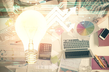 Double exposure of man and woman working together and bulb drawing. Computer background. Top View....