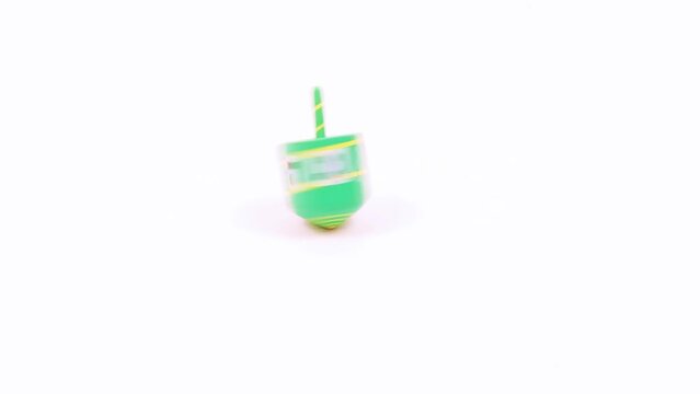 Hanukkah dreidel spins and stop, isolated over white, 4K, no sound